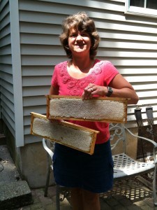 Mieke shows off a couple of frames of beautiful comb honey about to be cut.