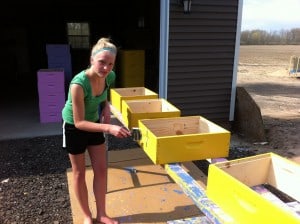 Traditionally, hives are painted white. We randomly pick out a number of bright happy colors, and our teenage daughters are more than happy to help out with the painting!